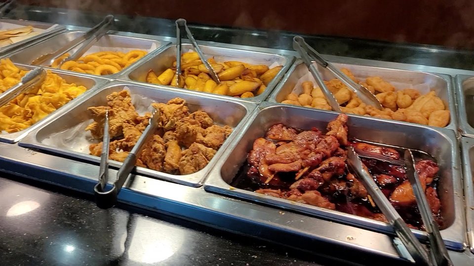 Rows of hot dishes and serving stations.